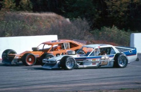 A young Mike Stefanik in the Evans' straight axle Modified runs side by side with Bobby Vee and his Chassis Dynamics creation. Both cars turned quite a few heads. Howie Hodge photo.