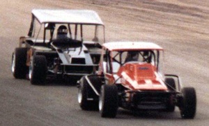 1979 Schaefer 200 winner, Jack Johnson (12a) looks up and sees a full mirror of Gary Balough on his tail during the 1980 Schaefer 200. Bob Scott photo.