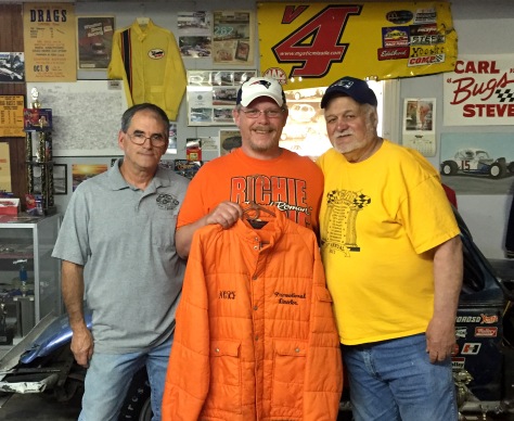 (Left to Right) ProNyne Motorsports Museum Curator, Ric Mariscal, yours truly holding our father's jacket and our father's friend and former boss, Speedway Scene owner, Val LeSieur.